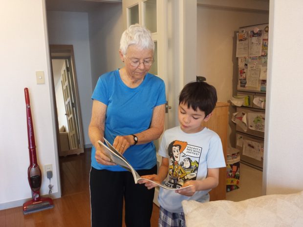 grandmother and grandson reading in clean house
